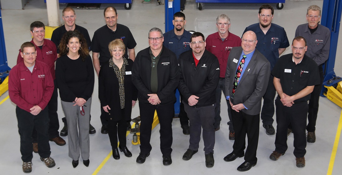 Bridgestone leaders Pat Graves (center, front) and Travis Koceja (right of Graves) joined FVTC faculty and others to celebrate a donation to automotive technology training. 